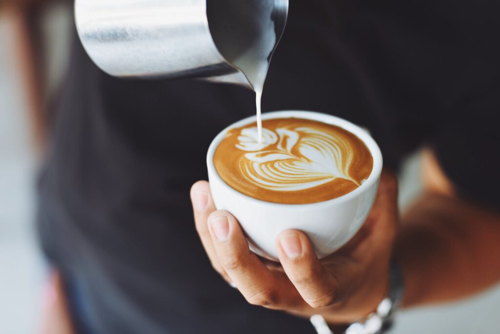 Person Performing Coffee Art decaf coffee
