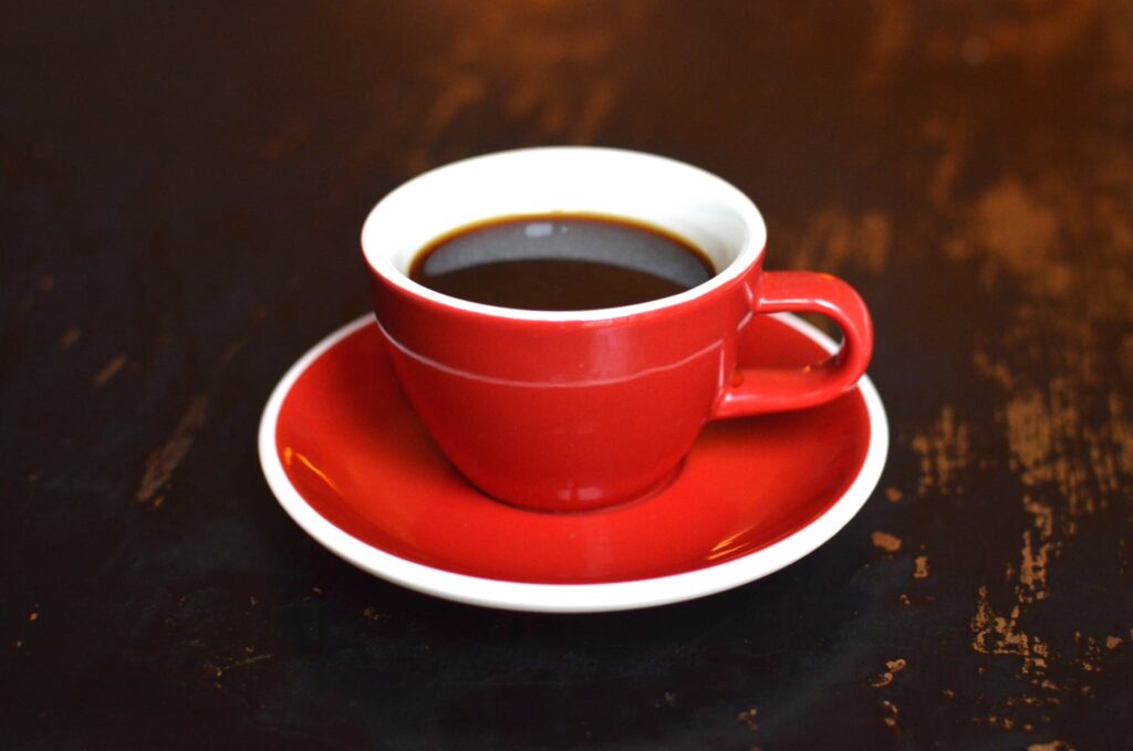 Cup of hot coffee on ceramic saucer americano vs espresso